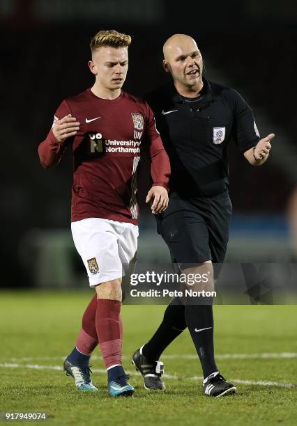 Sam Hoskins of Northampton Town walks from the pitch with referee Charles Breakspear during the Sky Bet League One match between Northampton Town and...