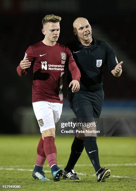 Sam Hoskins of Northampton Town walks from the pitch with referee Charles Breakspear during the Sky Bet League One match between Northampton Town and...