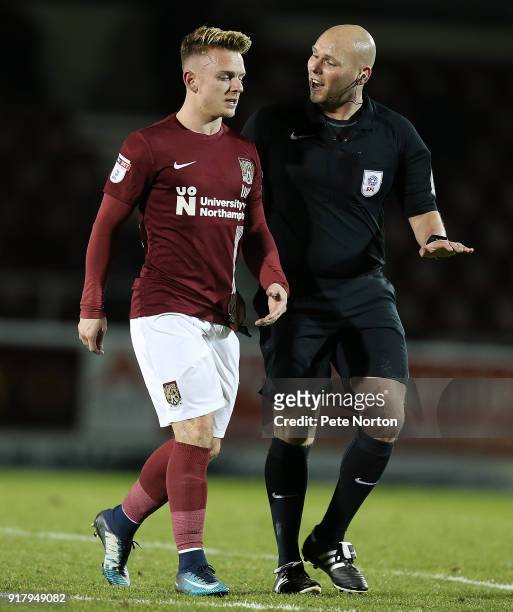 Sam Hoskins of Northampton Town walks from the pitch with referee Charles Breakspear during the Sky Bet League One match between Northampton Town and...