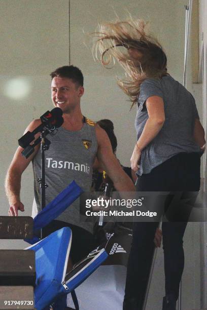 Liam Shiels of the Hawks helps evacuate the media conference location as a storm whips through during a Hawthorn Hawks AFL training session on...