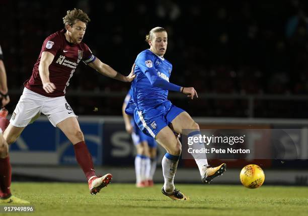 Tom Eaves of Gillingham plays the ball away from Ash Taylor of Northampton Town during the Sky Bet League One match between Northampton Town and...