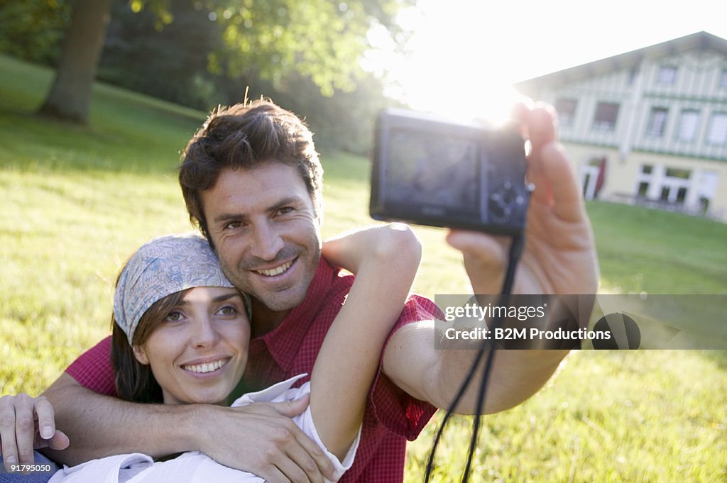 Couple posing for camera in backyard