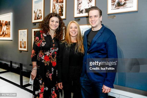 Initiator Andrea Bury, photographer Xiomara Bender and Dominik Elstner during the exhibition opening 'PortrAid - Get art. Give work.' at DRIVE...