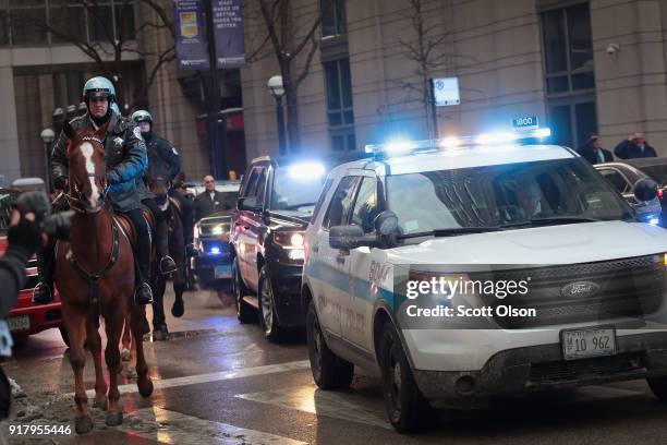 Chicago police officers join in the procession as an ambulance carrying the remains of Cmdr. Paul Bauer leaves Northwestern Memorial Hospital on...