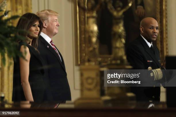 Vice Admiral Jerome Adams, the U.S. Surgeon General, right, speaks as U.S. President Donald Trump, second left, and First Lady Melania Trump listen...