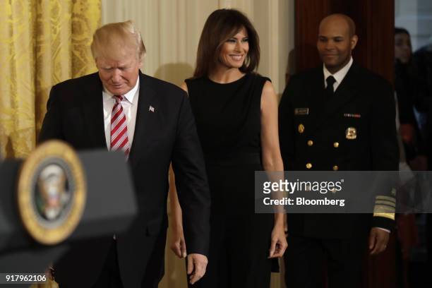 President Donald Trump, left, First Lady Melania Trump, center, and Vice Admiral Jerome Adams, the U.S. Surgeon General, arrive for a National...