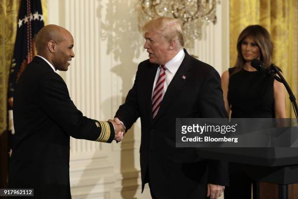 President Donald Trump, center, shakes hands with Vice Admiral Jerome Adams, the U.S. Surgeon General, during a National African American History...