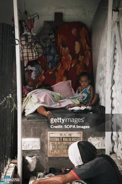Children seen sleeping on top of a gravestone at the slum in the cemetery. In the center of Pasay District of Metro Manila is a cemetery where over...