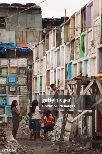 People seen at the slum of the cemetery. In the center of Pasay District of Metro Manila is a cemetery where over 10,000 deceased people is resting...