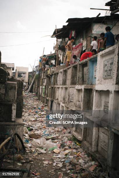 Local people seen living on top of multistoried high graves in a cemetery. In the center of Pasay District of Metro Manila is a cemetery where over...