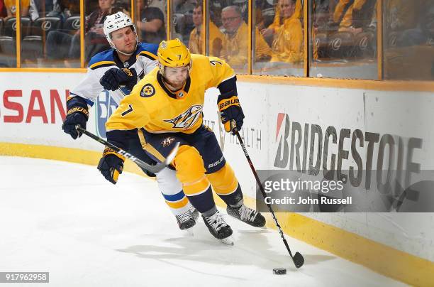 Yannick Weber of the Nashville Predators protects the puck against Vladimir Sobotka of the St. Louis Blues during an NHL game at Bridgestone Arena on...