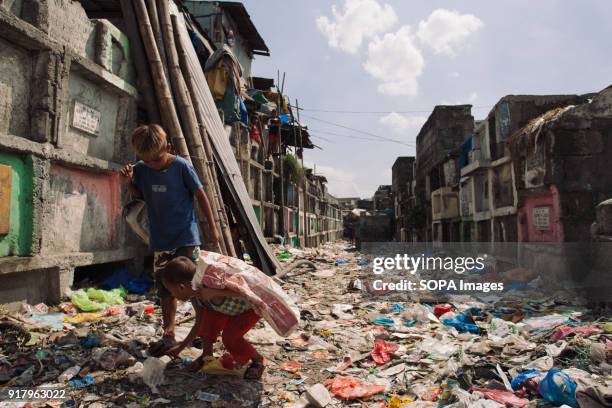 Local children seen at the slum in the cemetery. In the center of Pasay District of Metro Manila is a cemetery where over 10,000 deceased people is...