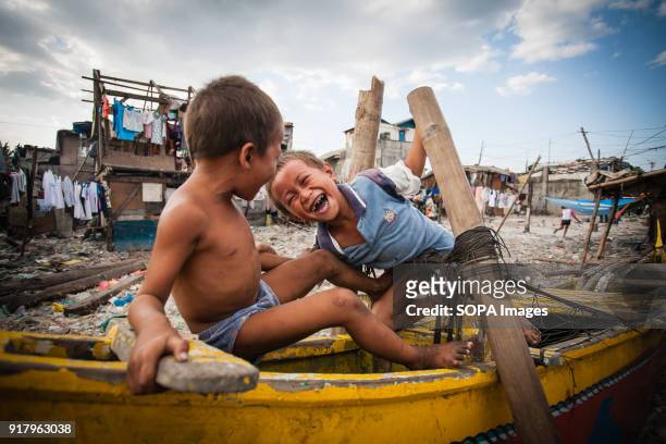 Local children seen playing at the slum in the cemetery. In the center of Pasay District of Metro Manila is a cemetery where over 10,000 deceased...