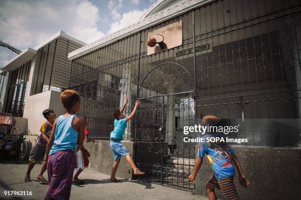 Children seen playing basketball in a slum in a cemetery. In the center of Pasay District of Metro Manila is a cemetery where over 10,000 deceased...