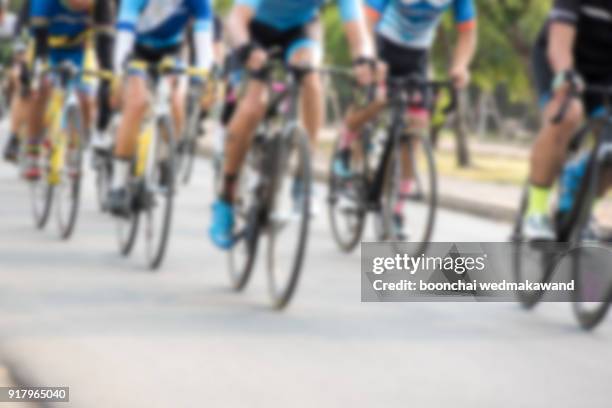 cycling competition,cyclist athletes riding a race at high speed / blur focus - pelotón términos deportivos fotografías e imágenes de stock