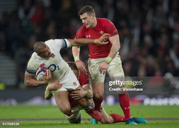 February 10: Jonathan Joseph of England is tackled by Hadleigh Parkes and Scott Williams of Wales during the NatWest Six Nations match between...