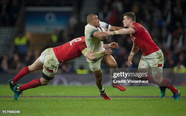 February 10: Jonathan Joseph of England is tackled by Hadleigh Parkes and Scott Williams of Wales during the NatWest Six Nations match between...