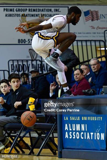 Johnson of the La Salle Explorers avoids collision with empty chairs against the St. Bonaventure Bonnies during the second half at Tom Gola Arena on...