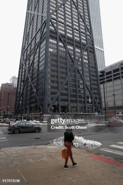 Pedestrian walks near the John Hancock Center, one of Chicago's most famous skyscrapers, on February 13, 2018 in Chicago, Illinois. John Hancock...