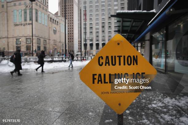 Pedestrians walk near the John Hancock Center, one of Chicago's most famous skyscrapers, on February 13, 2018 in Chicago, Illinois. John Hancock...