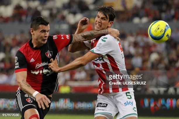Atlas's forward Milton Caraglio of Argentina vies for the ball with Necaxa's defender Igor Lichnovsky of Chile during their Mexican Clausura 2018...