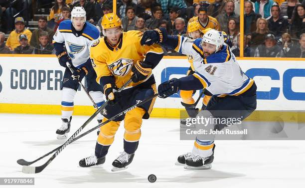 Calle Jarnkrok of the Nashville Predators skates against Robert Bortuzzo of the St. Louis Blues during an NHL game at Bridgestone Arena on February...