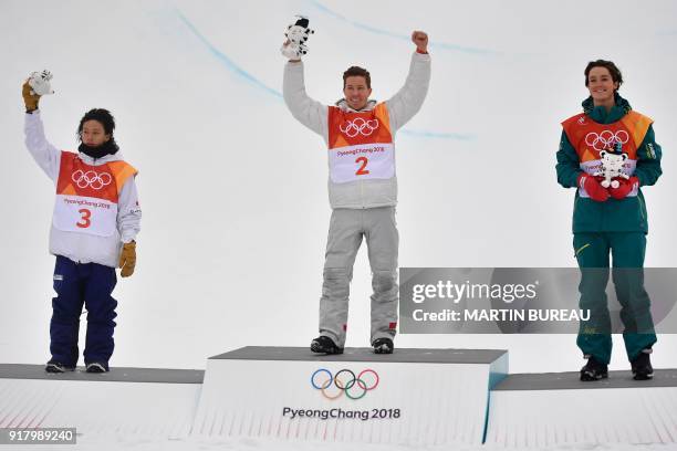 Japan's Ayumu Hirano, US Shaun White and Australia's Scotty James celebrate on the podium during the victory ceremony after the final of the men's...