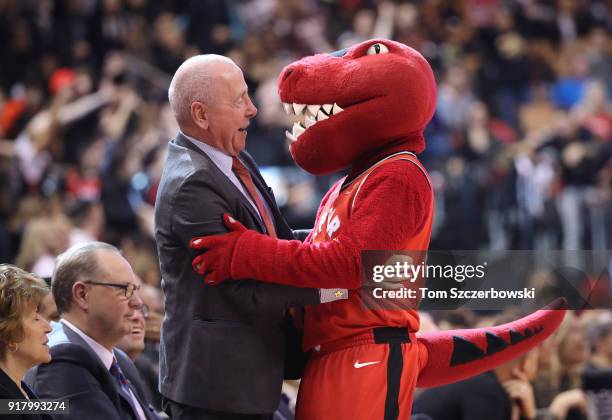 Chairman Larry Tanenbaum greets Toronto Raptors mascot the the during a break in the action of the game against the Miami Heat at Air Canada Centre...