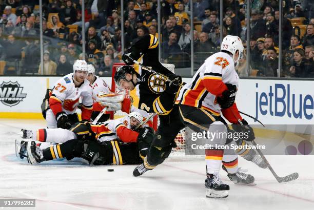 Calgary Flames center Sean Monahan trips up Boston Bruins center Patrice Bergeron during a game between the Boston Bruins and the Calgary Flames on...