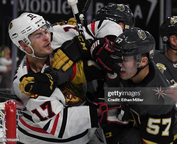 Lance Bouma of the Chicago Blackhawks and David Perron of the Vegas Golden Knights shove each other in front of the Golden Knight's net after play...