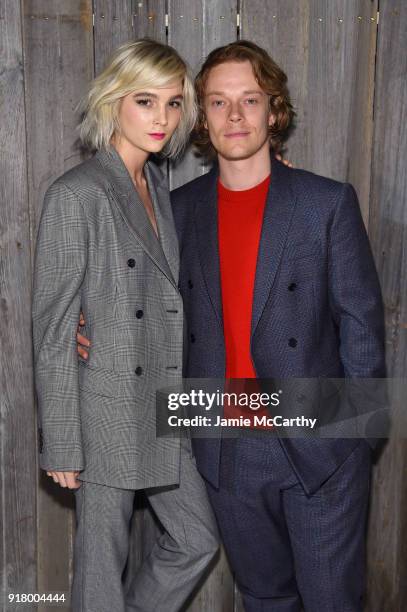 Allie Teilz and actor Alfie Allen attends the Calvin Klein Collection during New York Fashion Week at New York Stock Exchange on February 13, 2018 in...