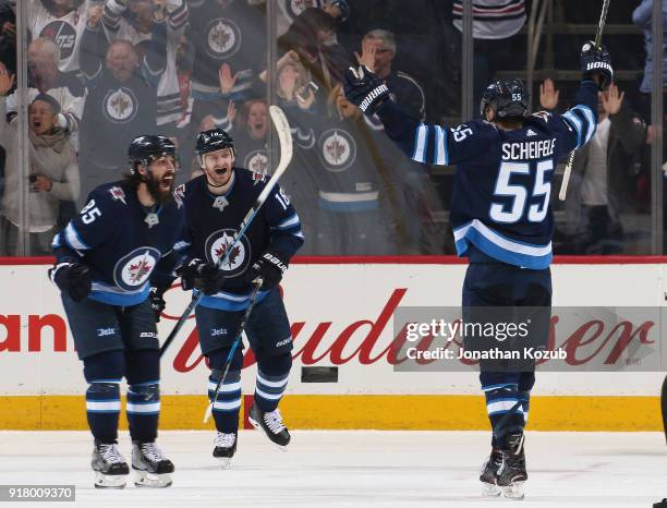 Mathieu Perreault, Bryan Little and Mark Scheifele of the Winnipeg Jets celebrate after scoring the tying goal late in third period action against...