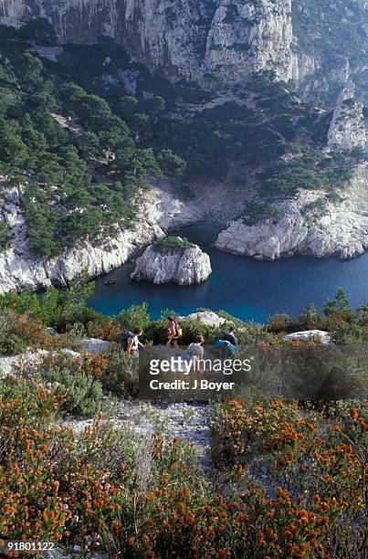 hikers on cliff, marseille, france - calanques stock pictures, royalty-free photos & images