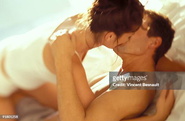 couple kissing in bed - 性交 ストックフォトと画像