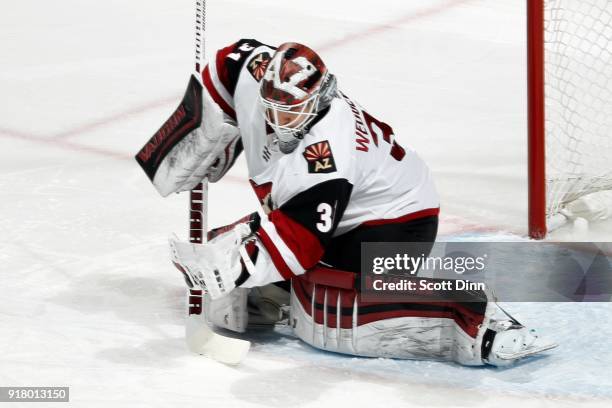 Scott Wedgewood of the Arizona Coyotes makes a glove save during a NHL game against the San Jose Sharks at SAP Center on February 13, 2018 in San...