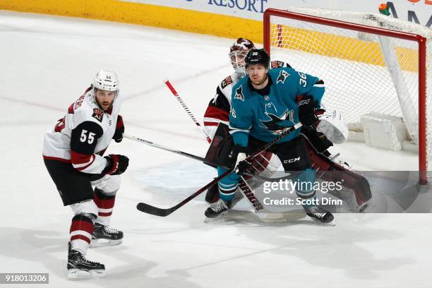 Jannik Hansen of the San Jose Sharks is defended by Jason Demers and Scott Wedgewood of the Arizona Coyotes at SAP Center on February 13, 2018 in San...