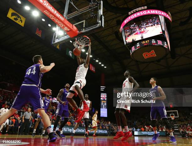 Mamadou Doucoure of the Rutgers Scarlet Knights dunks as Gavin Skelly of the Northwestern Wildcats watches during the second half of a game at...