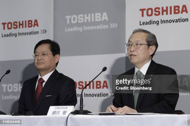 Satoshi Tsunakawa, outgoing chief executive officer of Toshiba Corp., right, speaks while Nobuaki Kurumatani, incoming chief executive officer and...