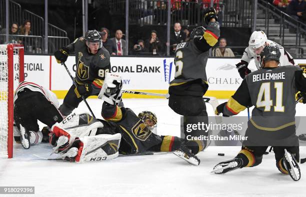 Marc-Andre Fleury of the Vegas Golden Knights continues to defend the net with teammates Nate Schmidt, Colin Miller and Pierre-Edouard Bellemare...