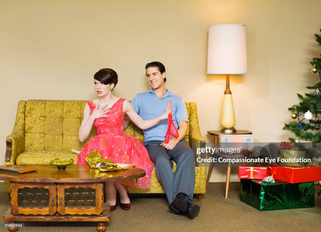 Woman with upset expression from recieving gift 