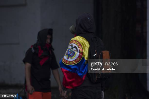 Protester carries a flag of Colombia and backpack within the clashes that broke out between students and riot police during a protest demanding...