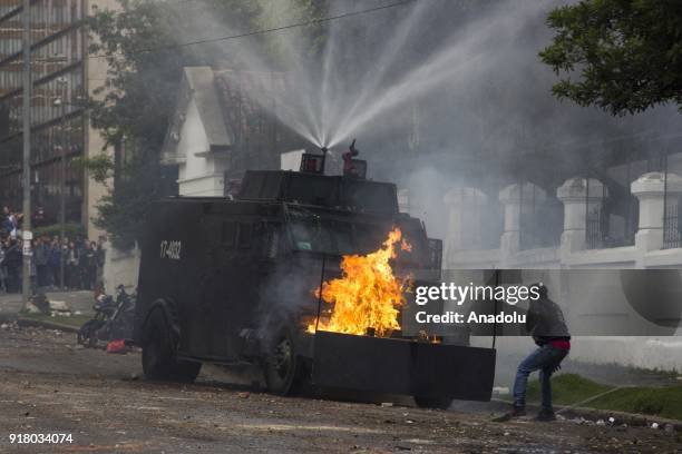 Mobile Anti-Disturbance Squadron sprays water as it partly burns on fire within the clashes that broke out between students and riot police during a...