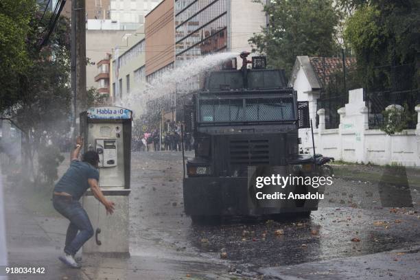 Mobile Anti-Disturbance Squadron sprays water at a protester within the clashes that broke out between students and riot police during a protest...