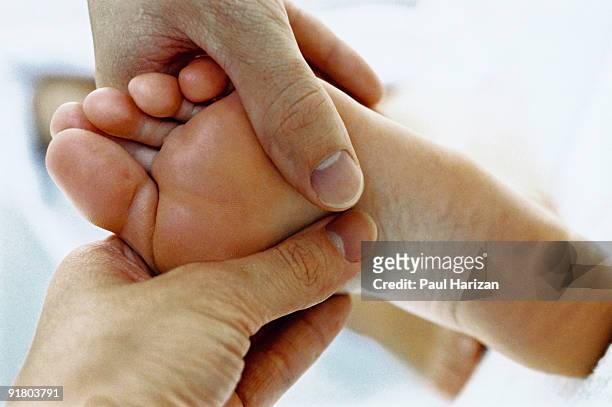 hands massaging foot - human foot anatomy stock pictures, royalty-free photos & images