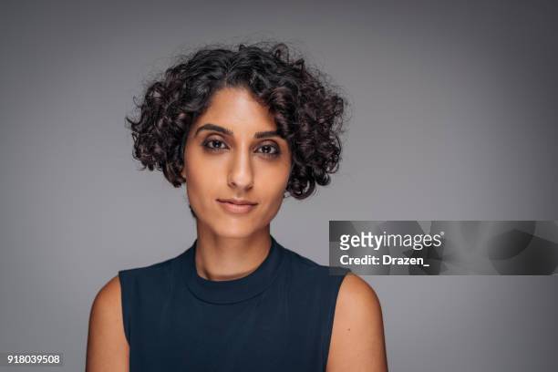 studio portrait of middle eastern adult woman, showing sadness and grief - 30 34 years stock pictures, royalty-free photos & images
