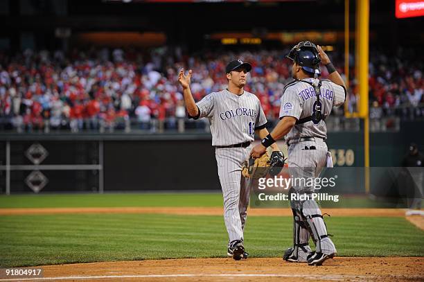 Huston Street of the Colorado Rockies and Yorvit Torrealba high five during Game 2 of the National League Division Series against the Philadelphia...