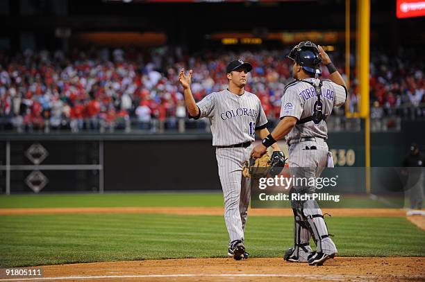 Huston Street of the Colorado Rockies and Yorvit Torrealba high five during Game 2 of the National League Division Series against the Philadelphia...