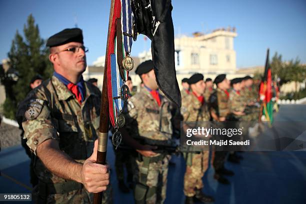 Italian soldiers with the NATO- led International Security Assistance Force stand to attention during a changing command ceremony, at the Provincial...