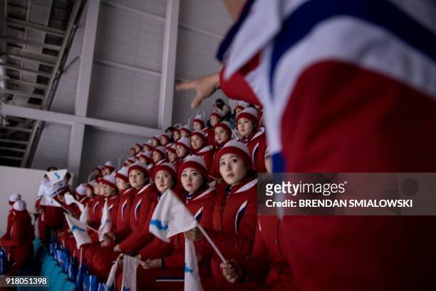North Korean cheerleaders wait for a women's preliminary round ice hockey match between Unified Korea and Japan during the Pyeongchang 2018 Winter...