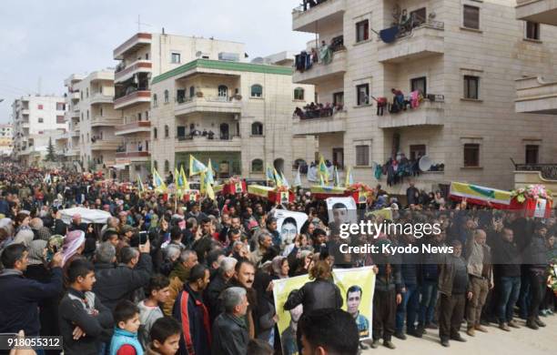 Kurdish residents gather for a memorial service for combatants killed in an armed conflict with the Turkish military in Afrin, northwestern Syria, on...